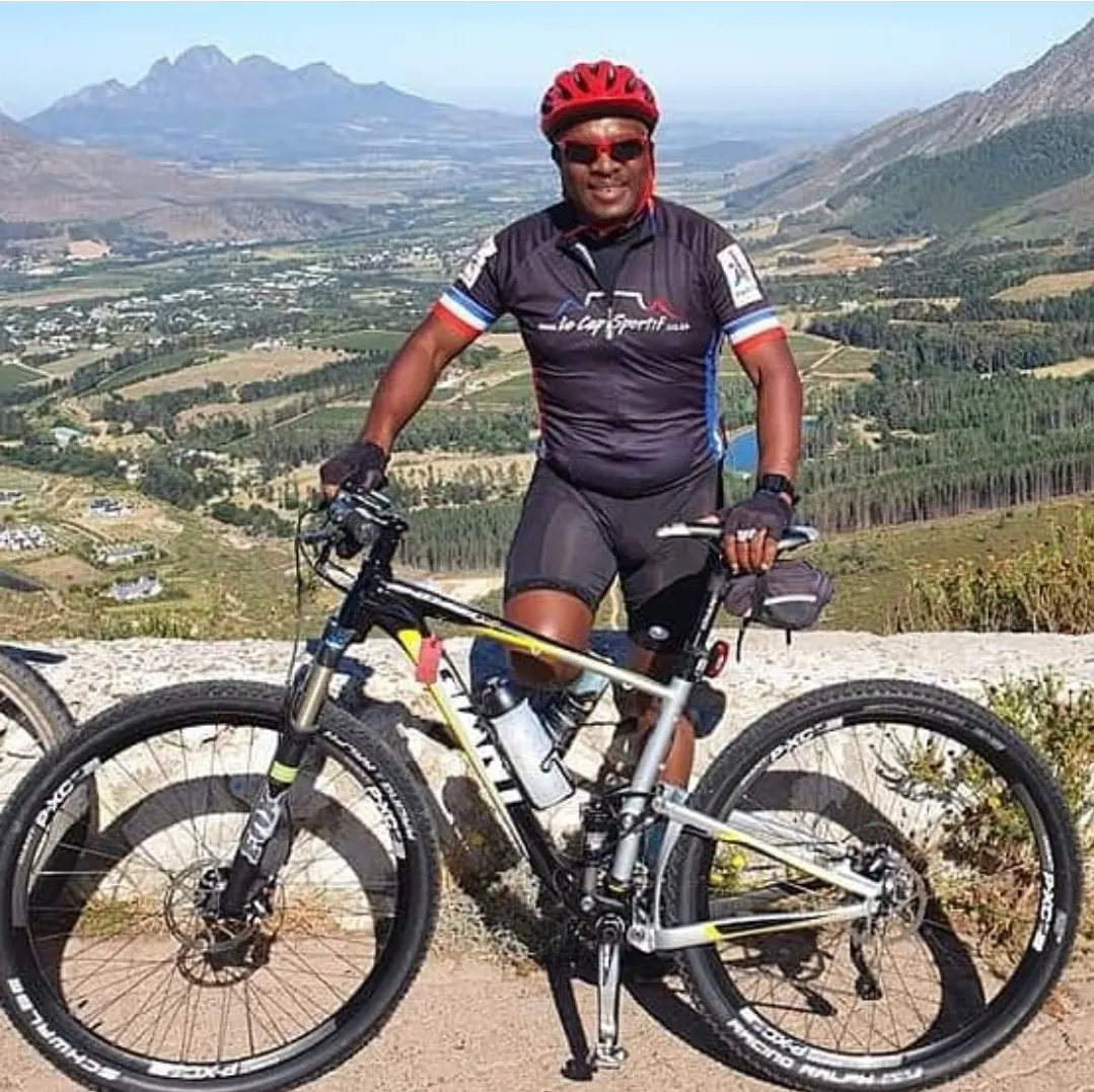 Solly Moeng with a mountain bike overlooking a valley