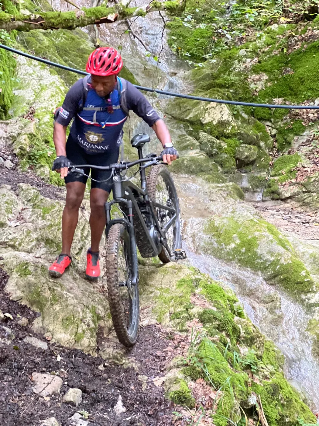Solly Moeng mountain biking on a rocky trail