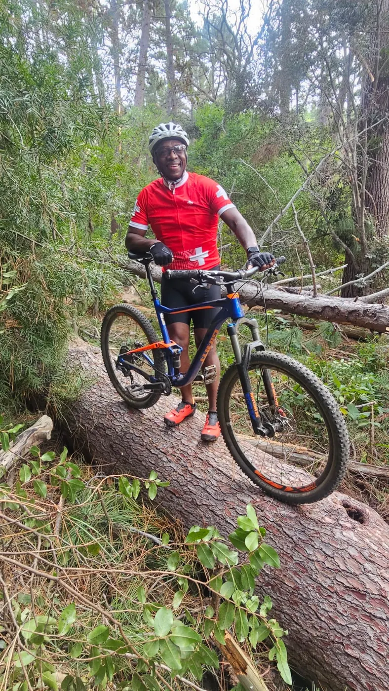 Solly Moeng with a mountain bike on a wooded trail