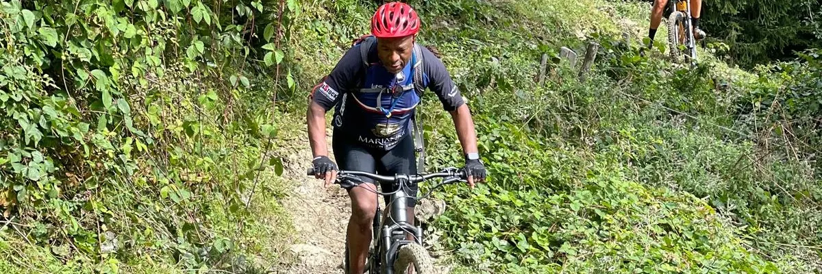 Solly Moeng riding a mountain bike on a trail